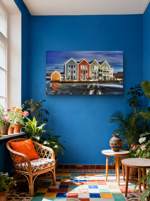 Living room with a blue wall, colorful painting of houses, and decorative furniture.