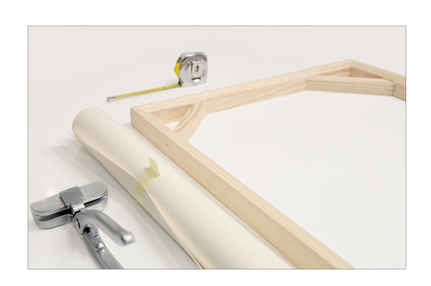 Wooden picture frame with tools on a white background