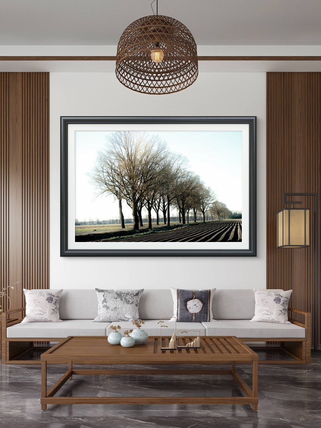 Living room with a framed landscape picture on the wall, wooden coffee table, and gray sofa.