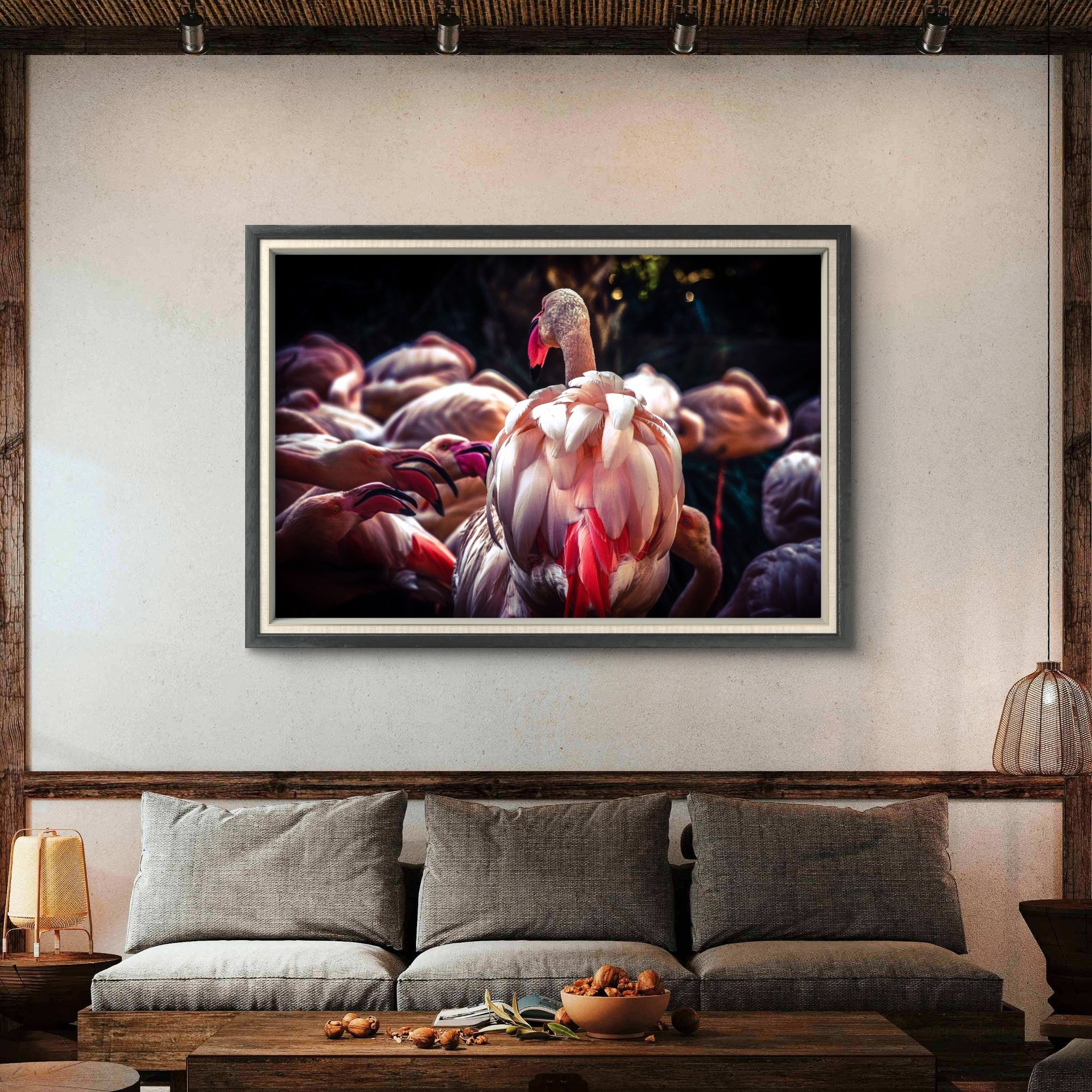 Framed artwork of a flamingo on a wall above a sofa in a living room.
