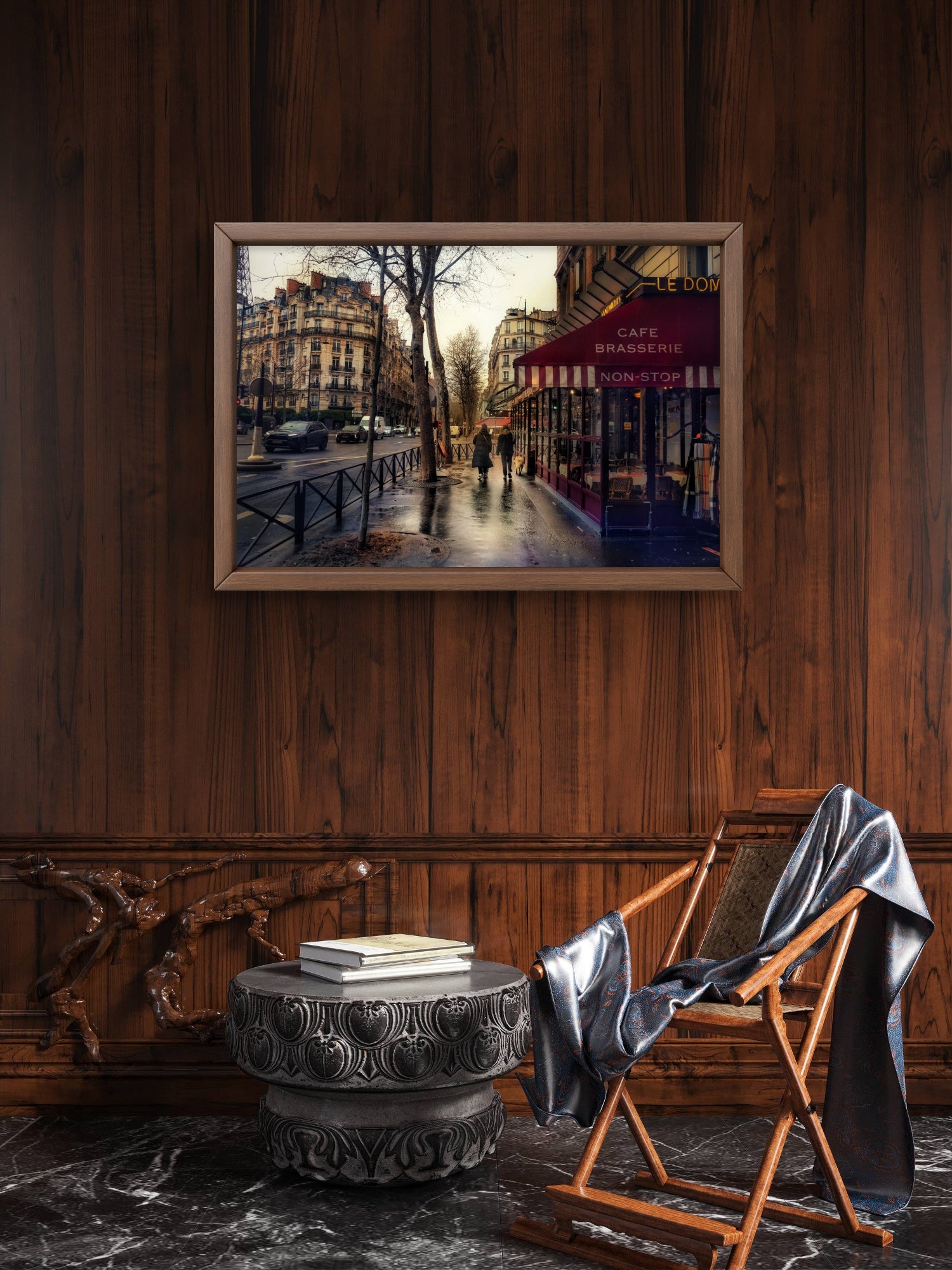 Framed artwork of a city street scene on a wooden wall above a decorative table and chair.