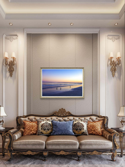 Decorative living room with a large sofa, decorative pillows, and a framed picture on the wall.