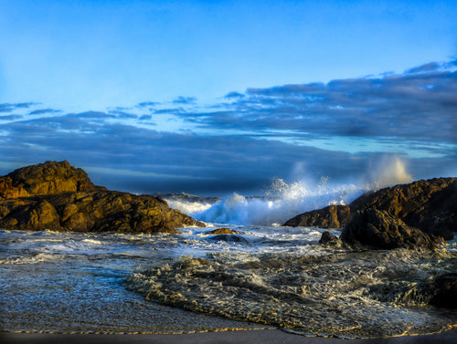 Ocean waves crashing against rocks with a blue sky and clouds. Yzerfontein Seascape Wall Print