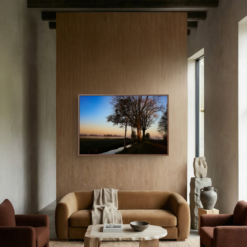 Modern living room with a TV displaying a nature scene, brown sofa, and armchairs.