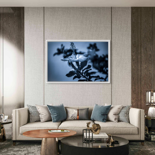 Modern living room with a floral artwork on the wall above a sofa.